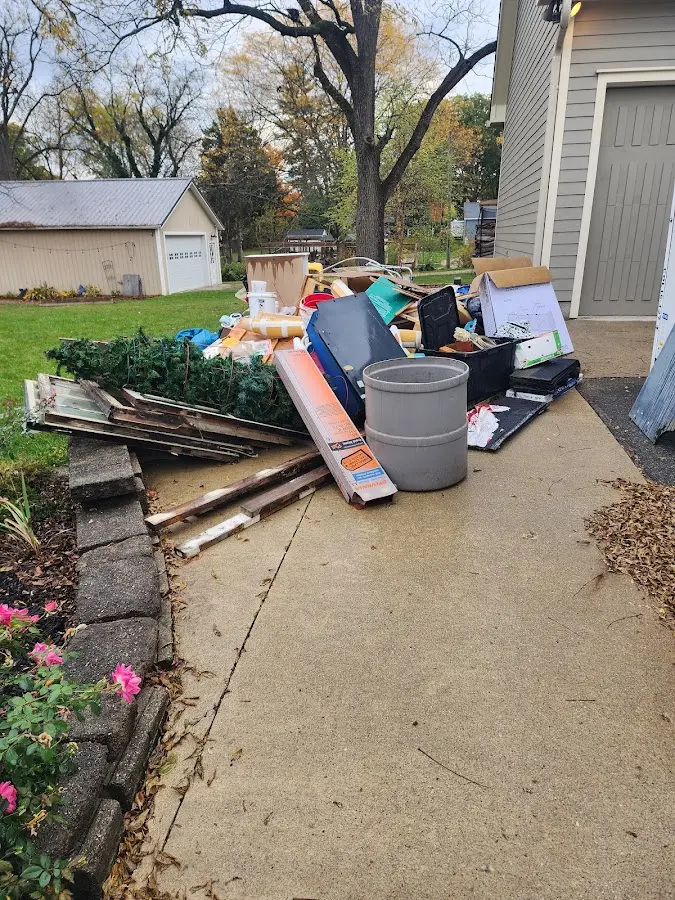 Dumpster being loaded with debris for Estate Cleanout Dumpster Rental in Euless